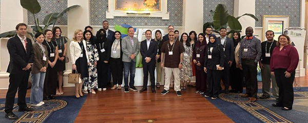 A group of people gathered for a photo with IIA CEO Anthony Pugliese.