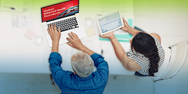 People gathered around a laptop